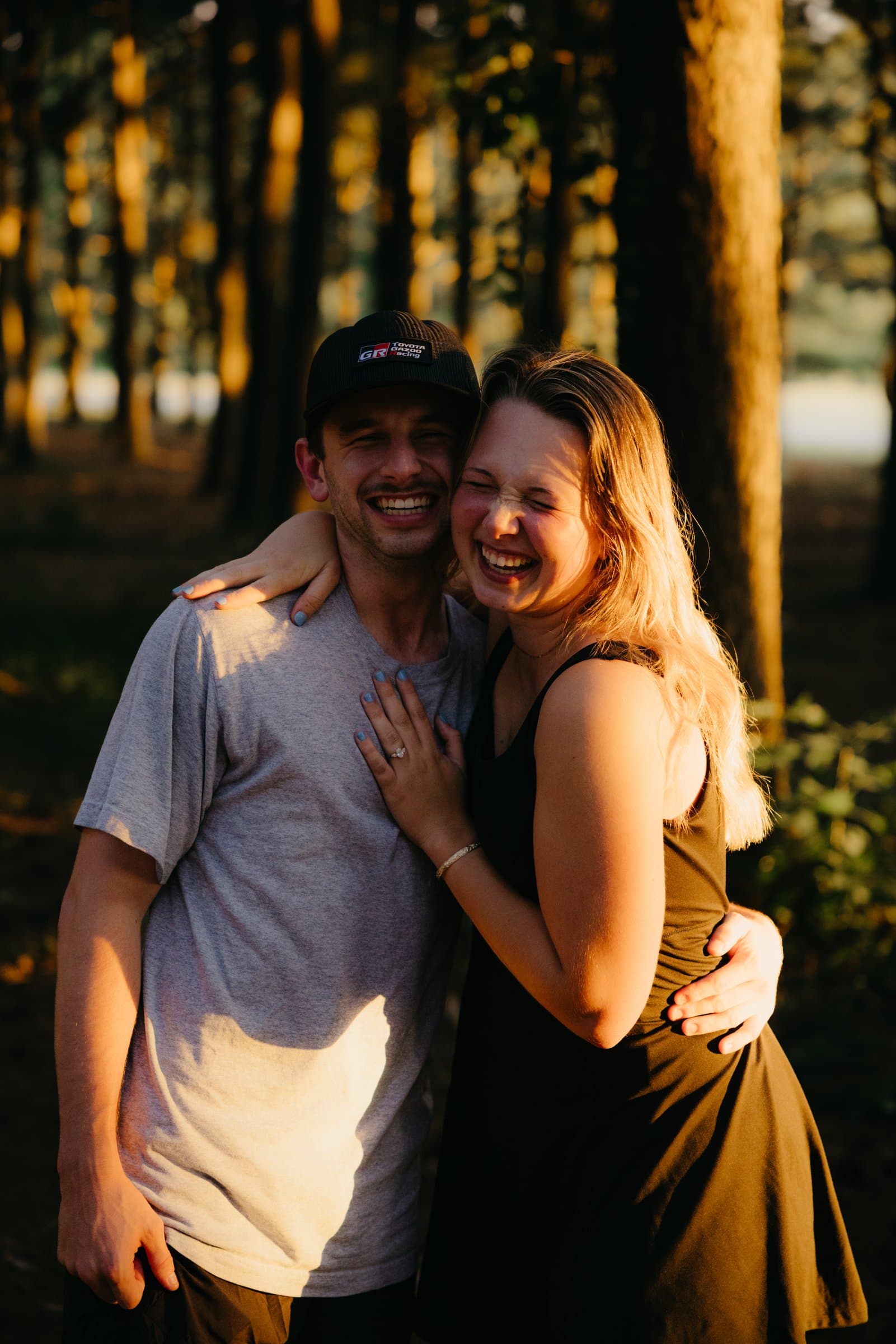 A couple laughing, close, in evening light