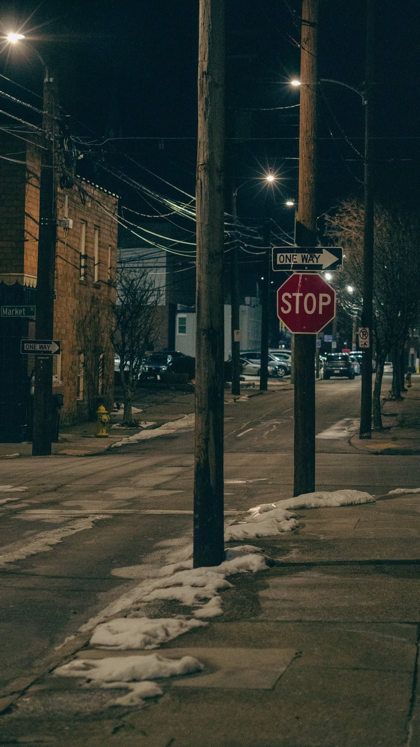 A Lexington street at night with a stop sign, teal and amber