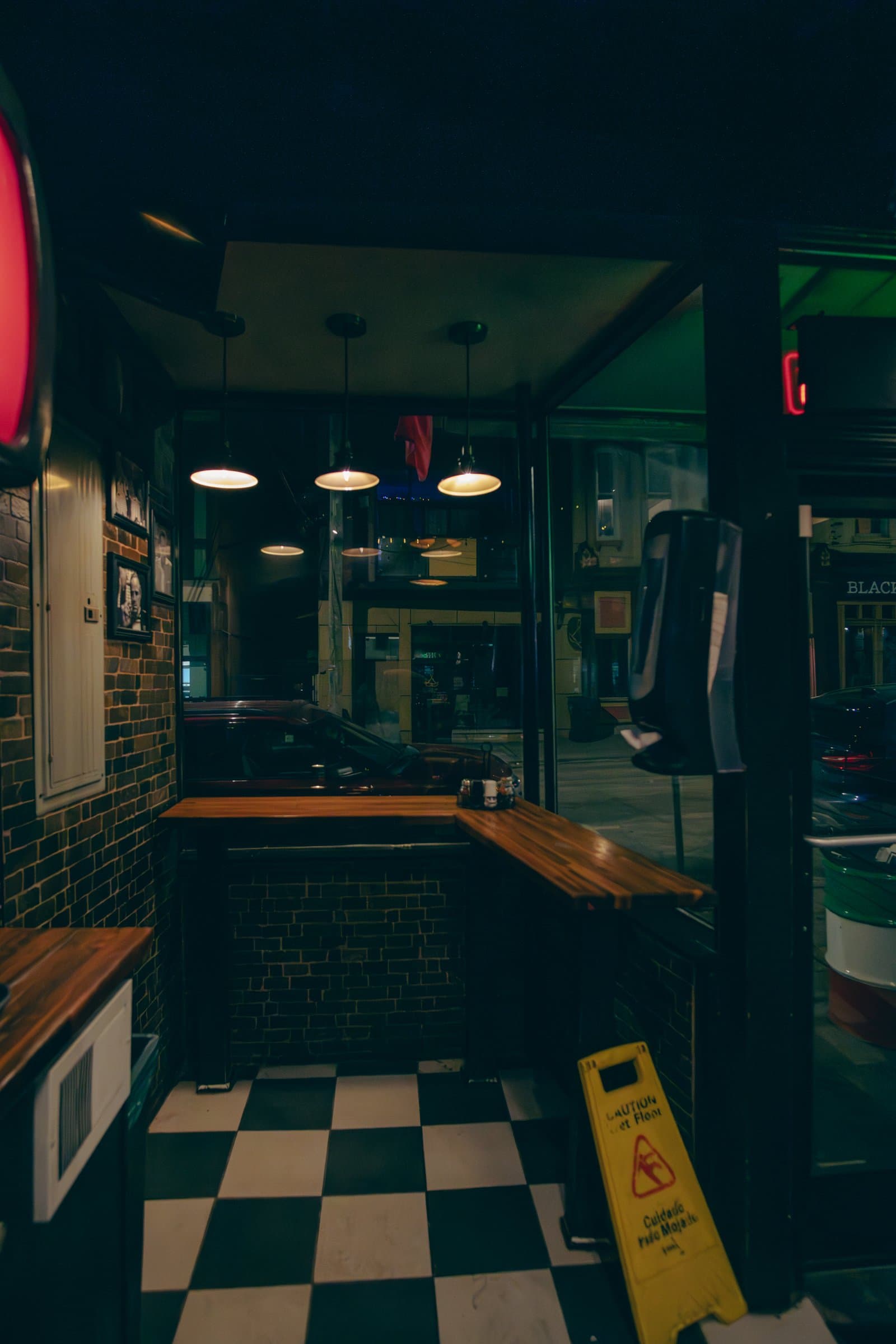 A diner interior at night in teal and red