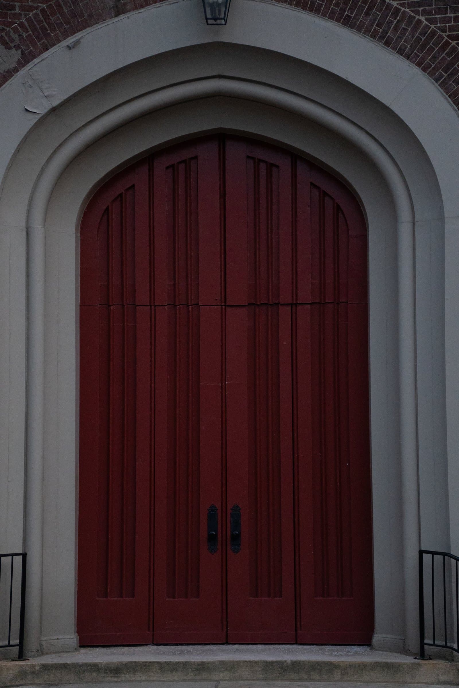 A red church door in a stone arch