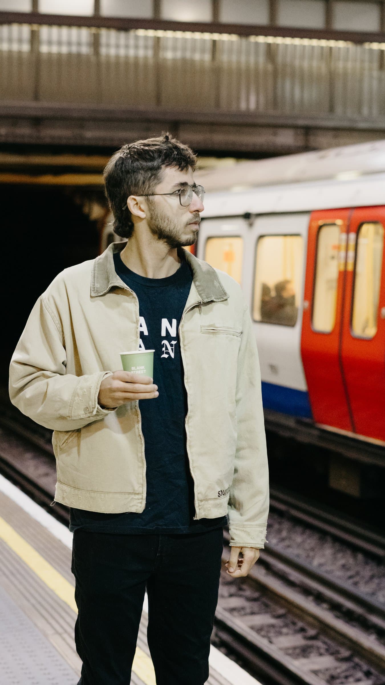 A portrait on an Underground platform as a train passes
