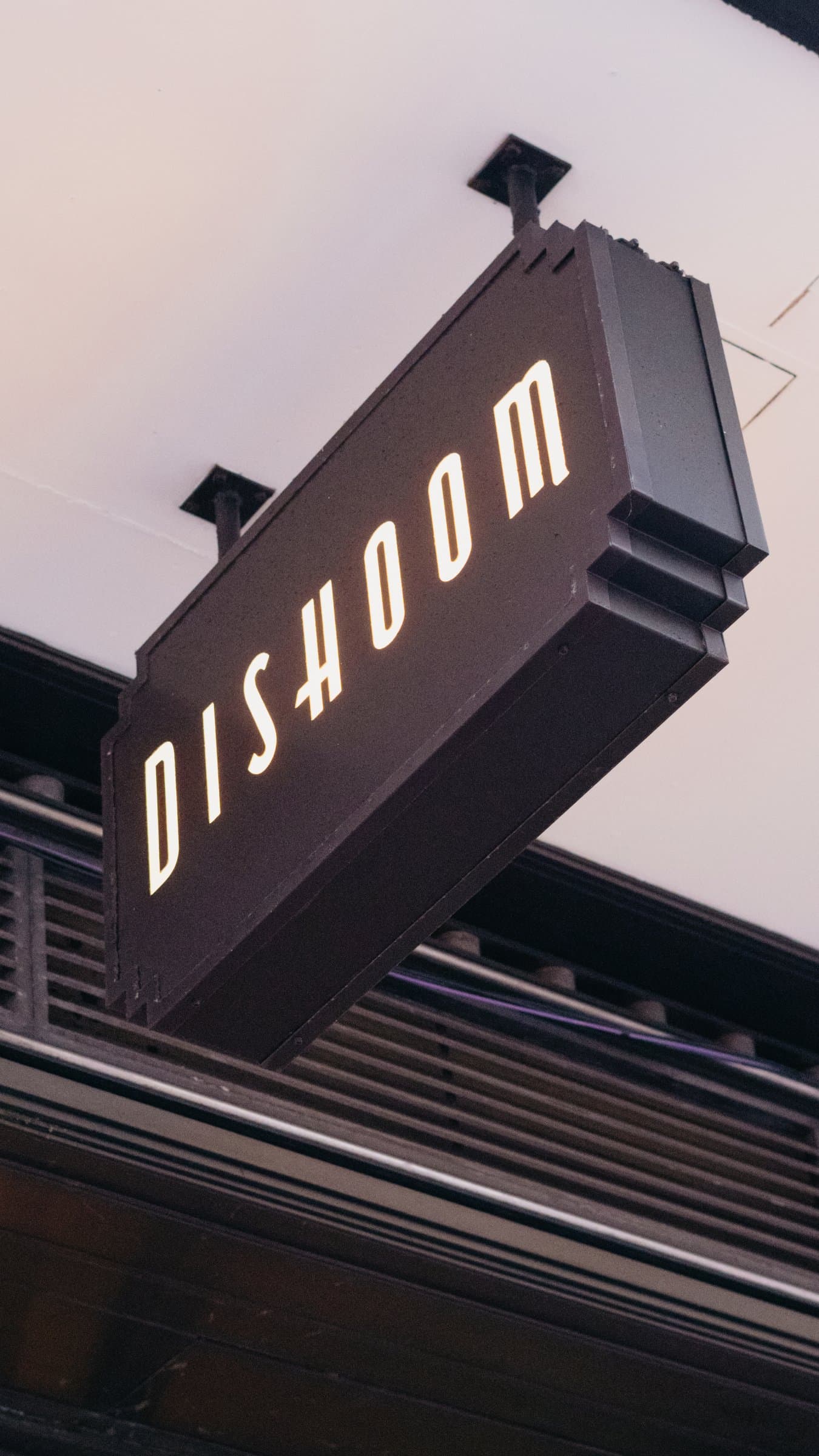 The Dishoom sign against the sky