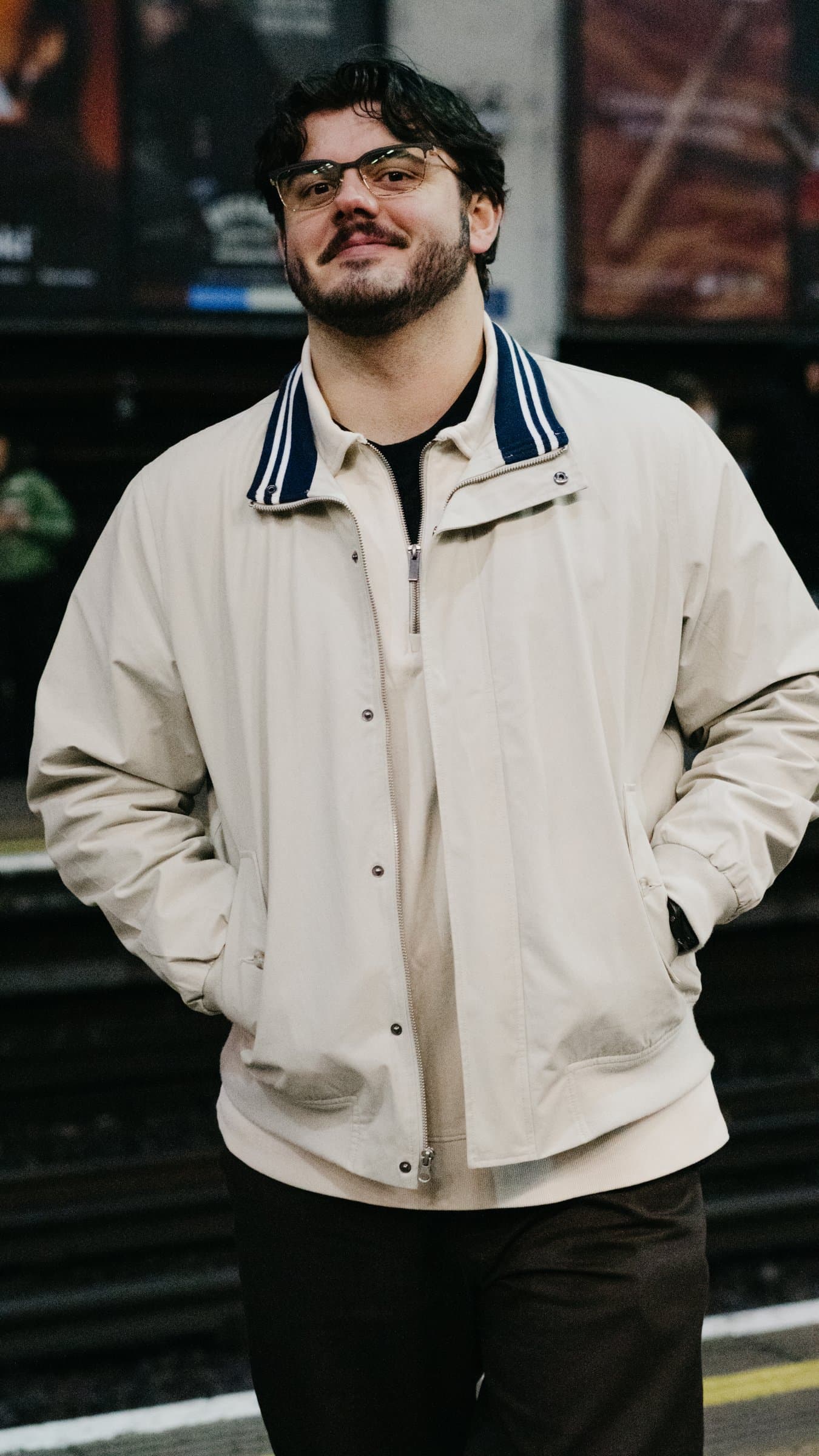 A portrait on an Underground platform in a white jacket
