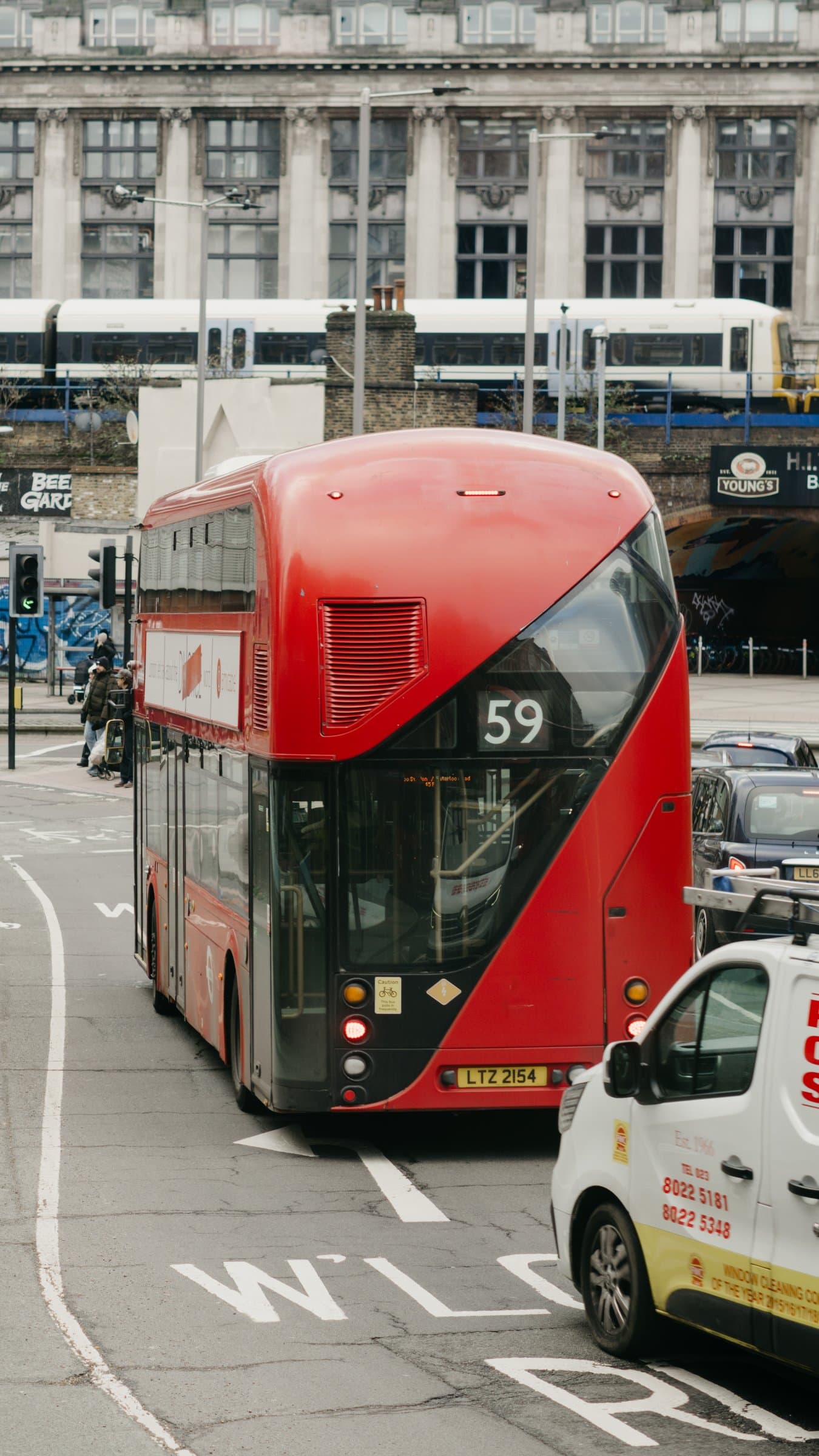 A red double-decker bus on a London street